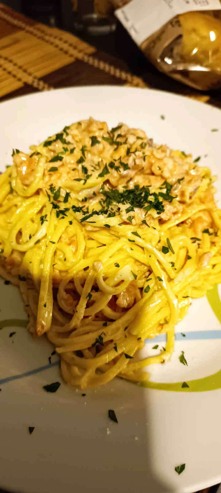Yellow pasta with a creamy sauce and herbs