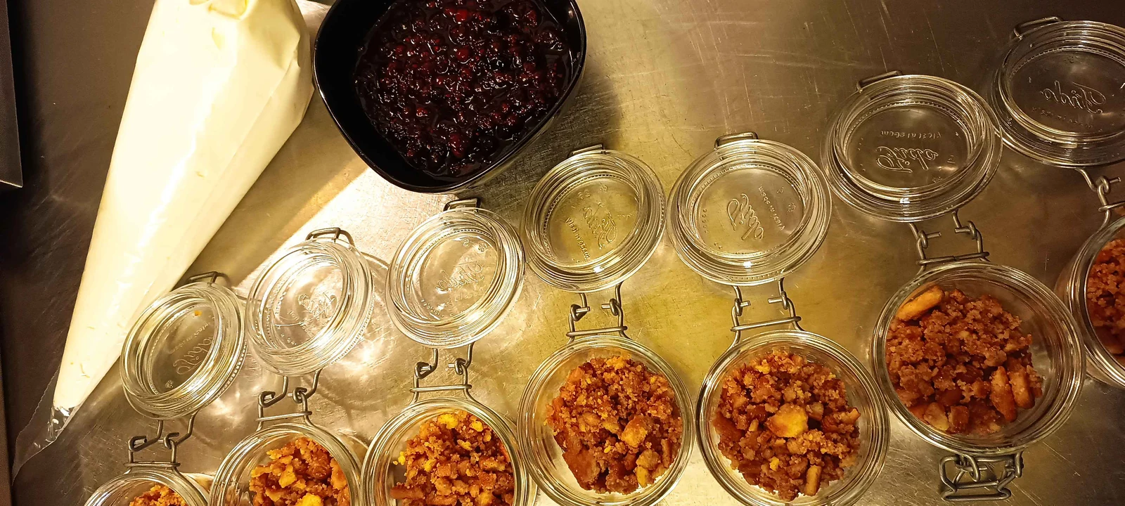 Jars of prepared condiments on a kitchen surface