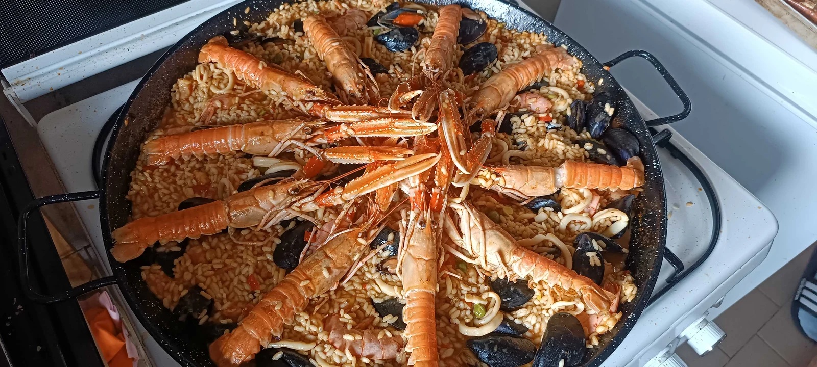 Seafood pan topped with langoustines